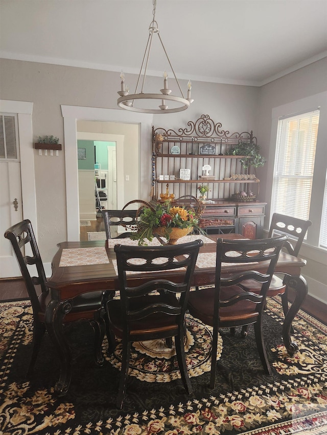 dining room featuring ornamental molding and a chandelier