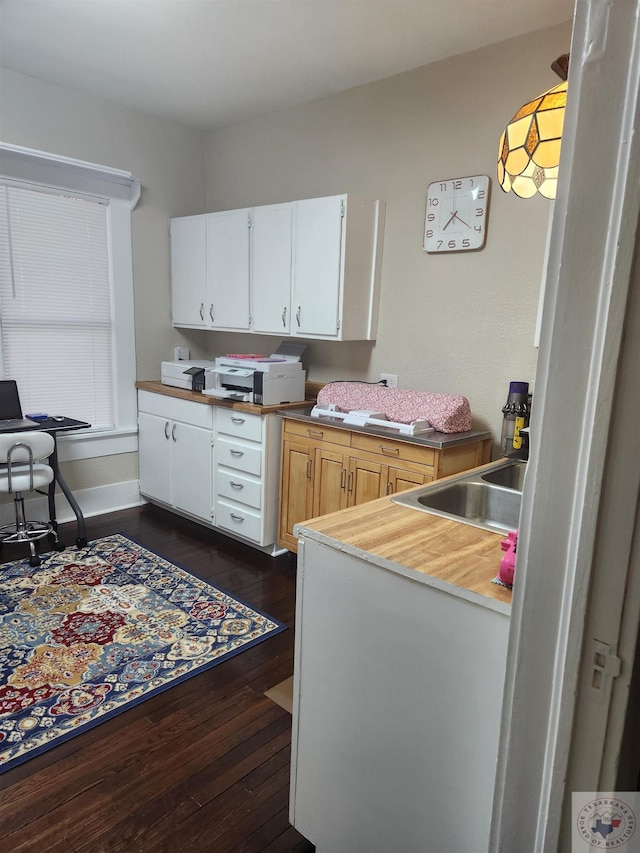 kitchen with sink, white cabinets, and dark hardwood / wood-style floors