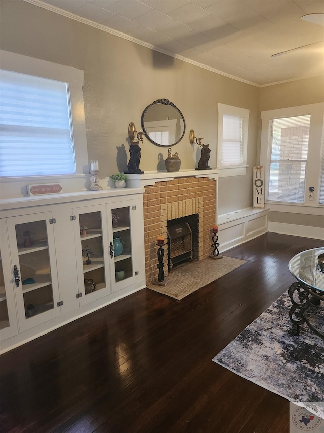 living room with dark wood-type flooring and ornamental molding