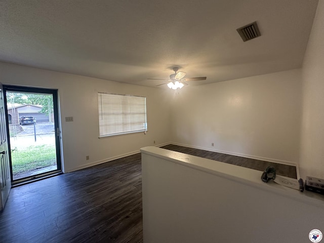 29 E Greenfield Dr, Wake Village, TX 75501 - unfurnished room with dark wood-style flooring, a ceiling fan, and baseboards