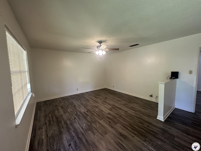 29 E Greenfield Dr, Wake Village, TX 75501 - spare room with dark wood-type flooring, a ceiling fan, and baseboards