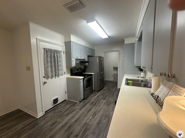 29 E Greenfield Dr, Wake Village, TX 75501 - kitchen featuring stainless steel appliances, a sink, dark wood-style floors, under cabinet range hood, and light countertops