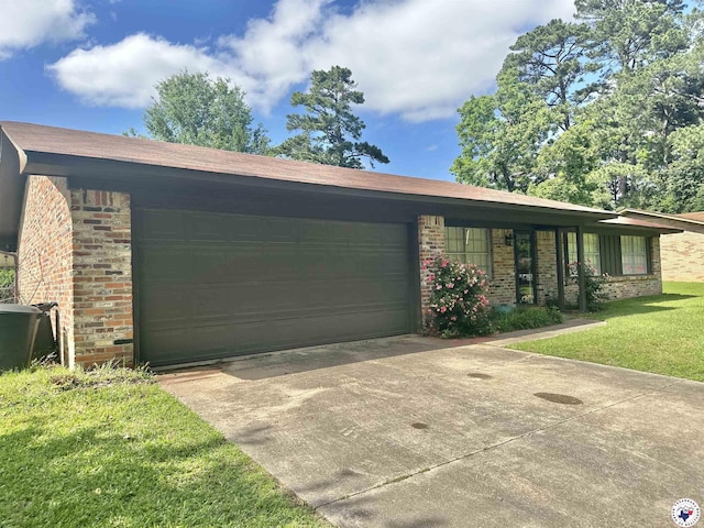 29 E Greenfield Dr, Wake Village, TX 75501 - view of front facade featuring brick siding, an attached garage, concrete driveway, and a front yard