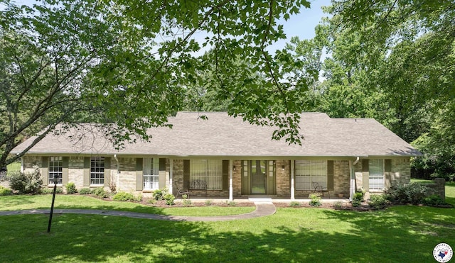 13 Holly Ridge Dr, Texarkana, TX 75503 - view of front facade featuring a front yard, roof with shingles, and brick siding