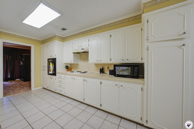 13 Holly Ridge Dr, Texarkana, TX 75503 - kitchen featuring black appliances, under cabinet range hood, white cabinetry, light countertops, and light tile patterned floors