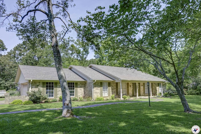 13 Holly Ridge Dr, Texarkana, TX 75503 - ranch-style house with a front lawn, an attached garage, brick siding, and a shingled roof