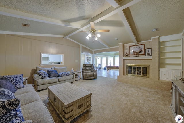 13 Holly Ridge Dr, Texarkana, TX 75503 - carpeted living room with arched walkways, a textured ceiling, a ceiling fan, and a fireplace