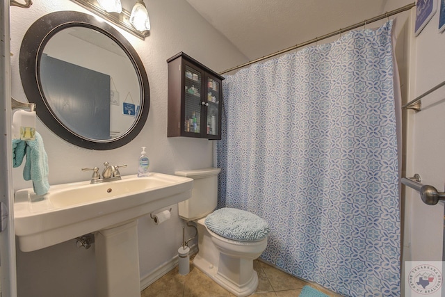 bathroom with walk in shower, toilet, and tile patterned flooring