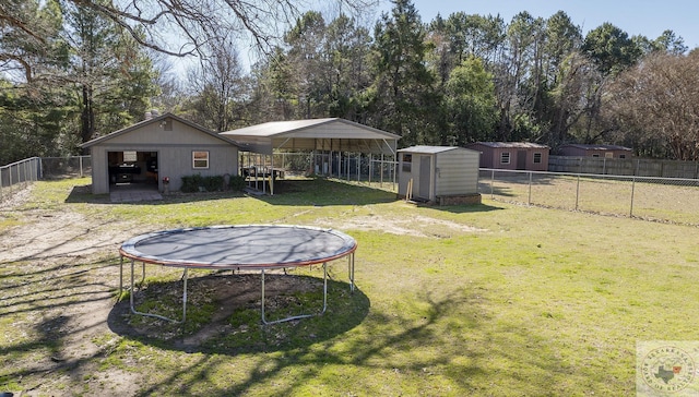 view of yard with a storage unit and a trampoline