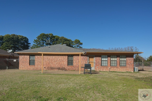 rear view of house with a patio and a yard