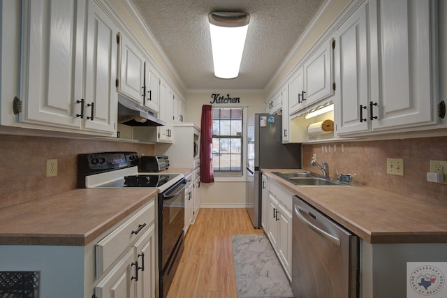 kitchen featuring appliances with stainless steel finishes, white cabinetry, light hardwood / wood-style floors, sink, and crown molding