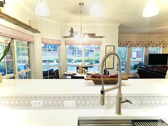 kitchen with a chandelier, hanging light fixtures, and ornamental molding