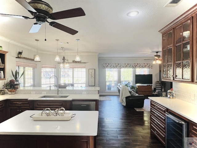 kitchen with beverage cooler, dark hardwood / wood-style flooring, sink, ornamental molding, and stainless steel dishwasher