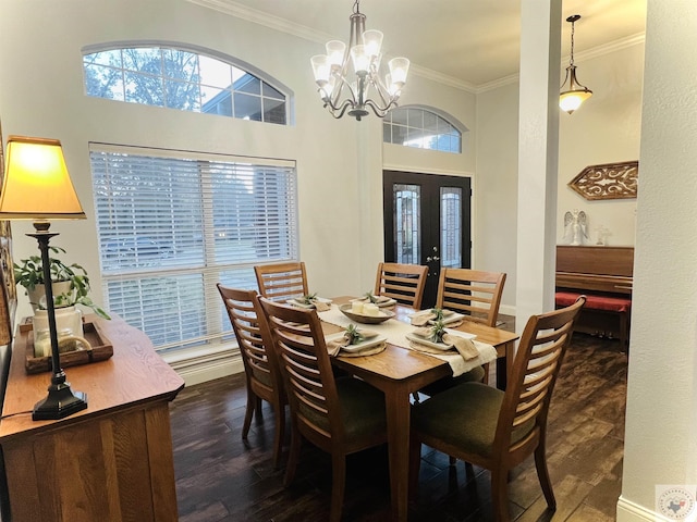 dining room featuring crown molding, dark wood-type flooring, a notable chandelier, and french doors