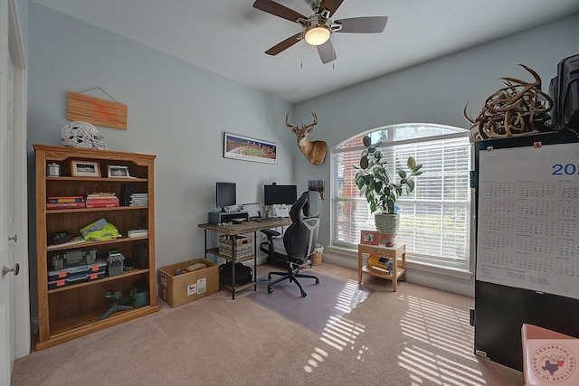 office space featuring light carpet and ceiling fan