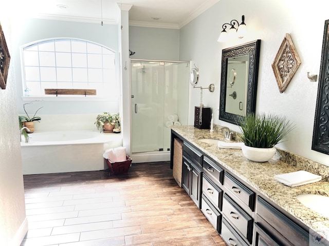 bathroom with hardwood / wood-style floors, vanity, crown molding, and shower with separate bathtub