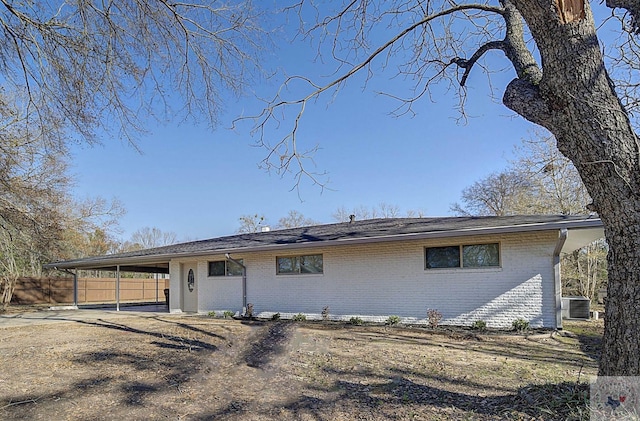 exterior space with a carport and central AC unit