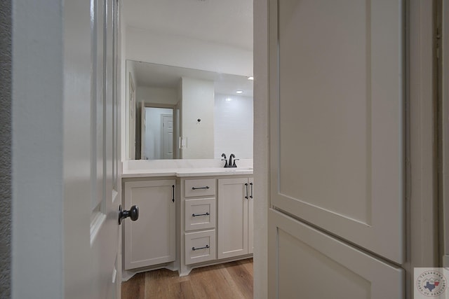 bathroom featuring hardwood / wood-style flooring and vanity