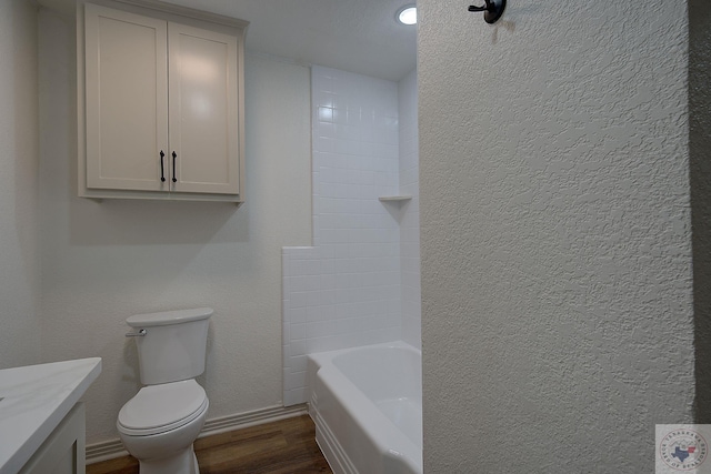 bathroom with wood-type flooring, toilet, and vanity