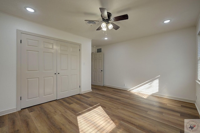 unfurnished bedroom with wood-type flooring, ceiling fan, and a closet