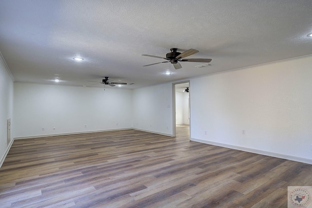 unfurnished room with ceiling fan, hardwood / wood-style floors, and a textured ceiling