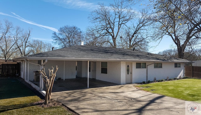 back of property featuring a carport and a yard