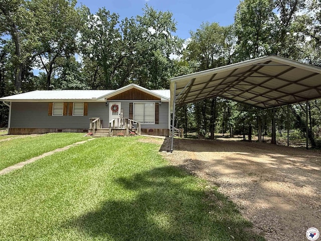 5440 Calico Duck Rd, Texarkana, AR 71854 - manufactured / mobile home featuring a detached carport, dirt driveway, a front yard, and view of wooded area