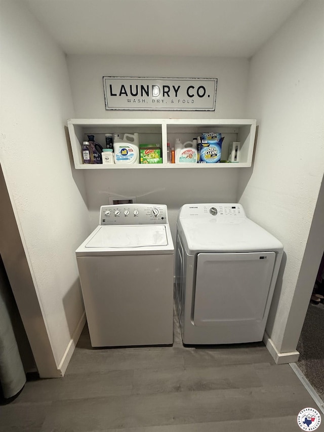 5440 Calico Duck Rd, Texarkana, AR 71854 - washroom with washing machine and clothes dryer and wood finished floors