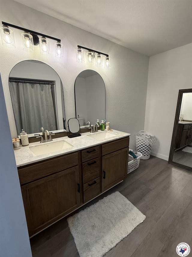 5440 Calico Duck Rd, Texarkana, AR 71854 - bathroom featuring wood finished floors and double vanity