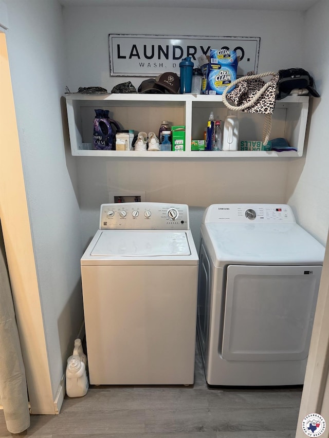 5440 Calico Duck Rd, Texarkana, AR 71854 - washroom featuring washer and clothes dryer and wood finished floors