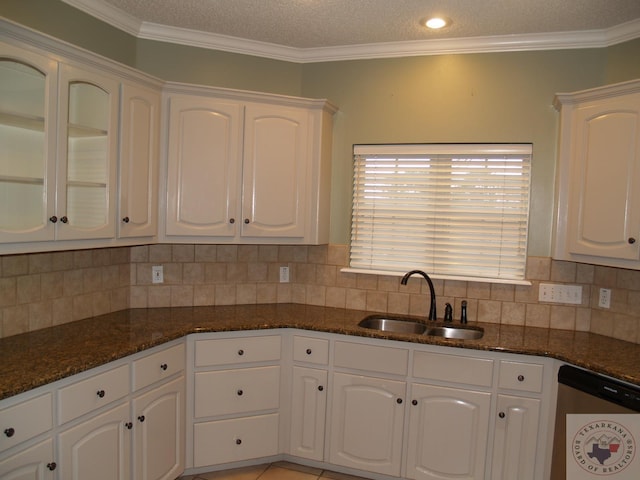 7311 Shilling Cir, Texarkana, TX 75503 - kitchen with a sink, stainless steel dishwasher, white cabinetry, dark stone countertops, and ornamental molding