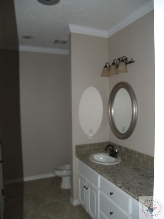 7311 Shilling Cir, Texarkana, TX 75503 - bathroom featuring toilet, vanity, crown molding, baseboards, and tile patterned floors