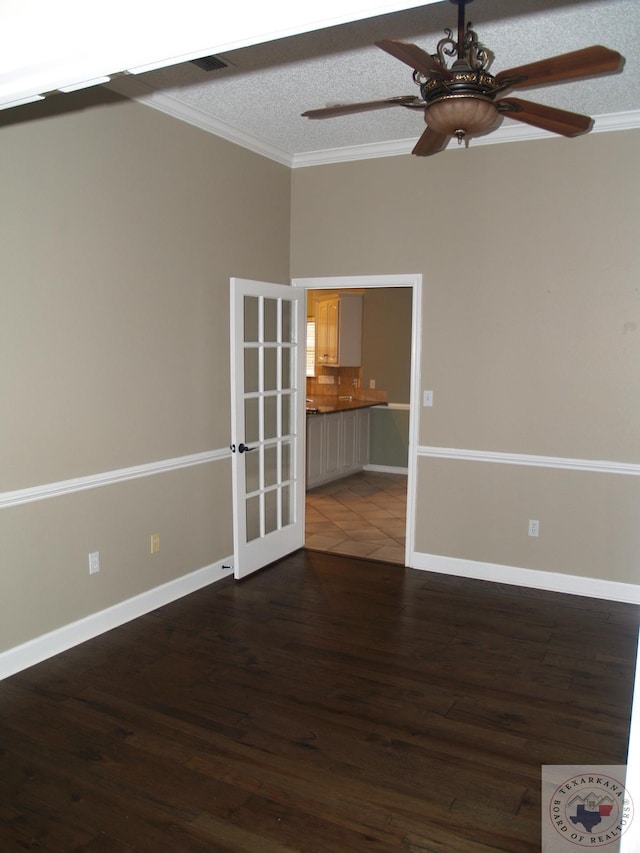 7311 Shilling Cir, Texarkana, TX 75503 - spare room with crown molding, a ceiling fan, wood finished floors, french doors, and baseboards