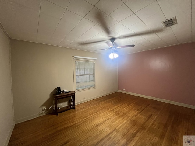 empty room featuring hardwood / wood-style flooring and ceiling fan