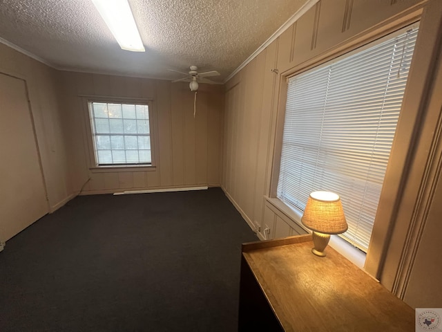 unfurnished room with crown molding, a textured ceiling, and ceiling fan