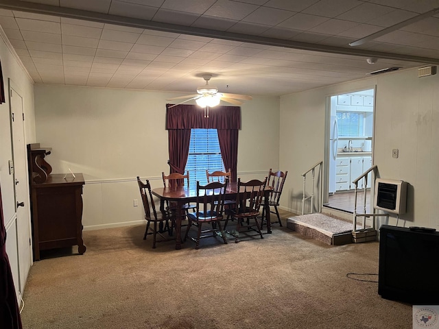 dining room featuring sink, ceiling fan, heating unit, and carpet floors