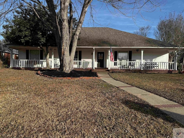 view of front of home with a front yard and covered porch