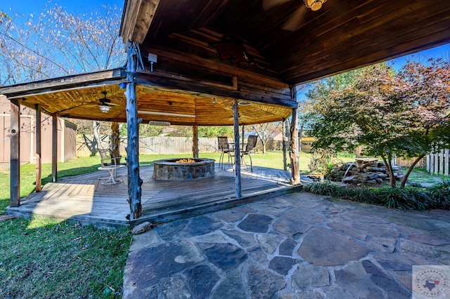 view of patio / terrace featuring a wooden deck and a fire pit