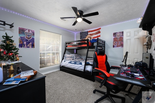 bedroom with ceiling fan, carpet flooring, and a textured ceiling