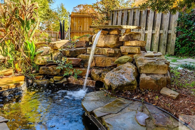 view of yard featuring a garden pond