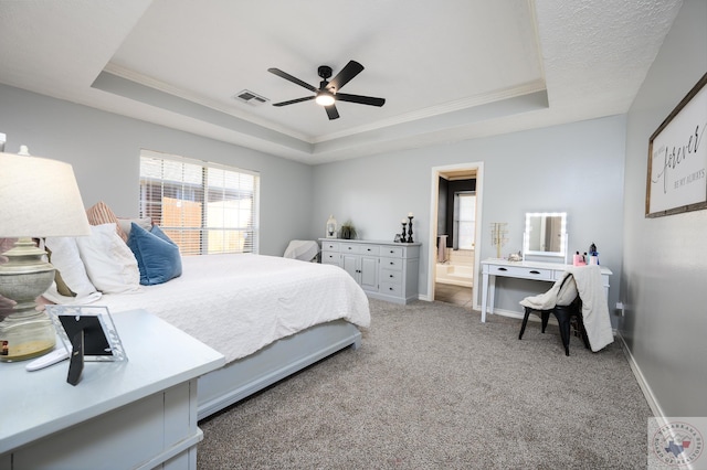 bedroom featuring ceiling fan, carpet, and a raised ceiling