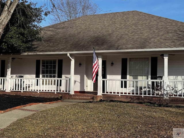 view of front of home with covered porch and a front yard