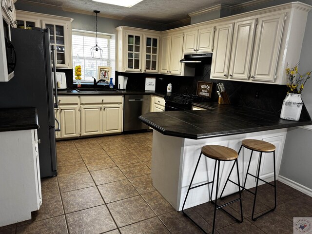 kitchen featuring a breakfast bar, decorative light fixtures, ventilation hood, appliances with stainless steel finishes, and kitchen peninsula