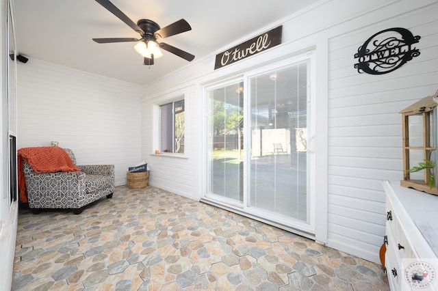 interior space with ceiling fan