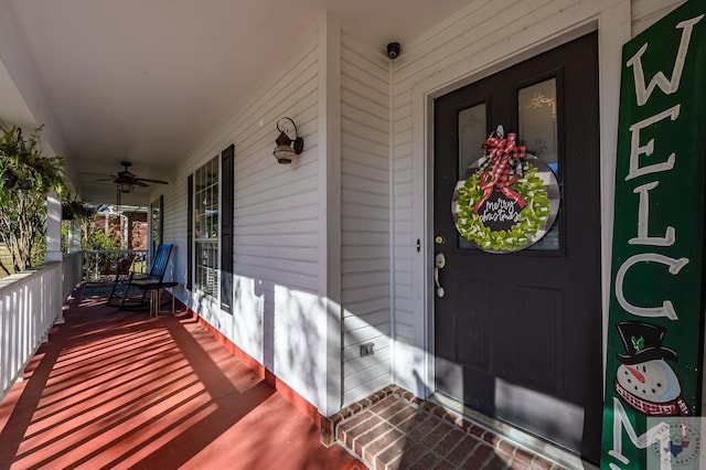 entrance to property with a porch and ceiling fan