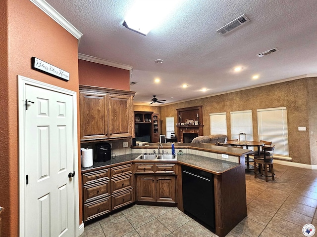 kitchen featuring ceiling fan, a sink, light tile patterned floors, a peninsula, and black dishwasher