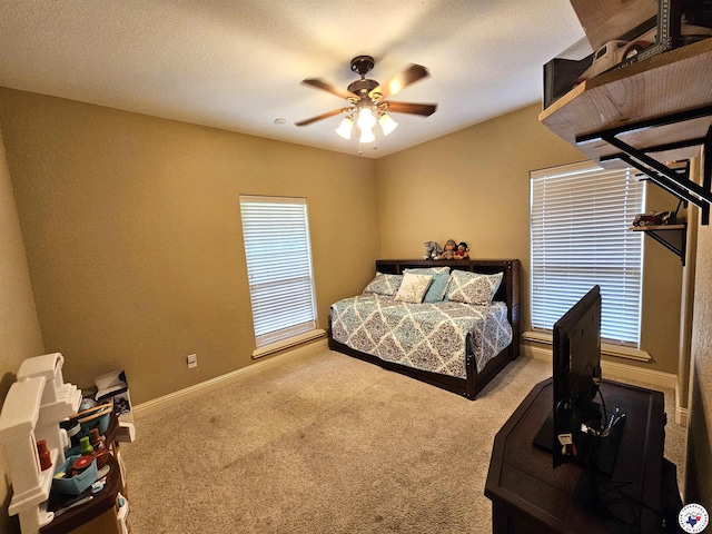 bedroom with a ceiling fan, baseboards, and carpet