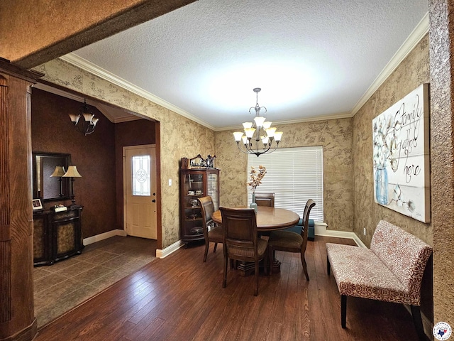 dining area with a textured ceiling, a chandelier, ornamental molding, and wood finished floors