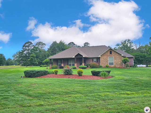 view of front of property with stone siding and a front yard