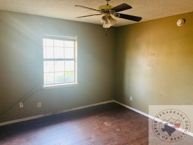 spare room with ceiling fan, dark hardwood / wood-style floors, and a textured ceiling